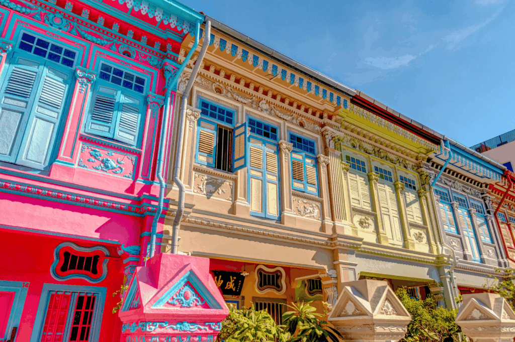 A vibrant row of Peranakan-style shophouses along East Coast Road and jalan besar, near iconic laksa stalls like Janggut Laksa, Asia Delight Laksa, Yishun Laksa, Sungei Road Laksa, and Ng Chwee Seng. These coffee shop and food centre locations are home to Singapore Katong laksa and katong laksa, often served in a regular bowl or small bowl with just a spoon. The laksa recipe features rice noodles, thick bee hoon, and noodles soaked in creamy laksa gravy made from coconut milk, evaporated milk, fresh coconut, and milk, cooked with laksa paste, blue ginger, dried shrimp, dried oysters, sambal, spices, sugar, lard, and garnish, then simmered to perfection. Toppings include fish cake, fishcake, fried tofu puffs, tofu puffs, tau pok, bean sprouts, hard boiled egg, fresh prawns, prawns, cockles, blood cockles, chicken, and seafood. This tasty, savoury, spicy dish is a personal favourite among Singapore laksa lovers, known for its flavourful gravy, rich broth, and unforgettable taste. Whether at roxy square or a hidden stall that opens with unique opening hours, this food experience is a must-eat in Singapore.
