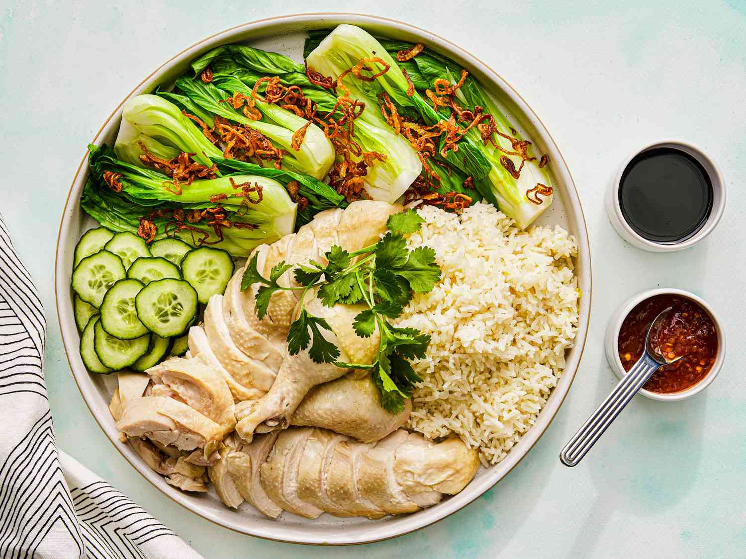 Hainanese Chicken Rice Singapore : A perfectly poached chicken served with fragrant rice and chilli sauce