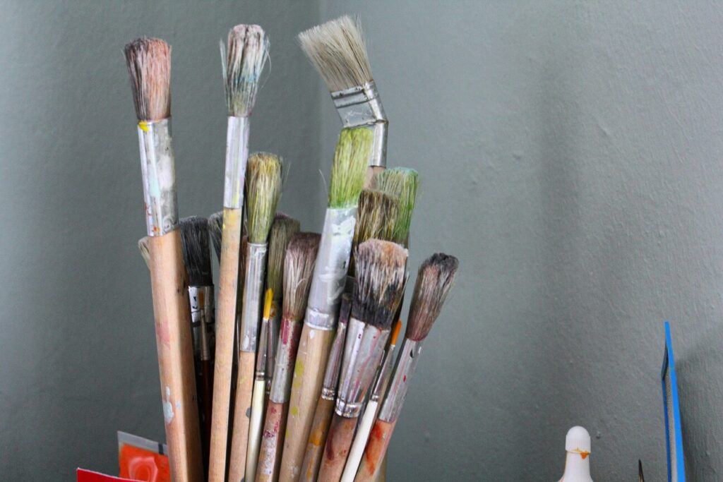 Singapore Public Art: Paint brushes arranged neatly beside sketches for a community mural project.