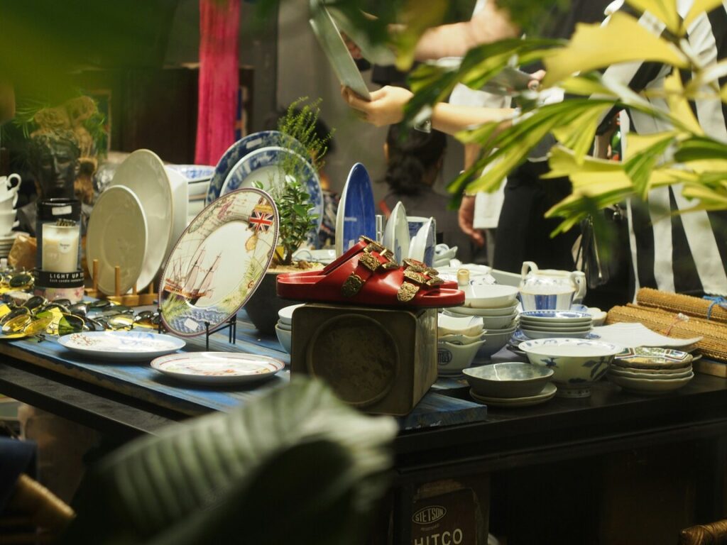 Community Markets Singapore : People exploring secondhand treasures and collectibles in a vibrant market setting.
