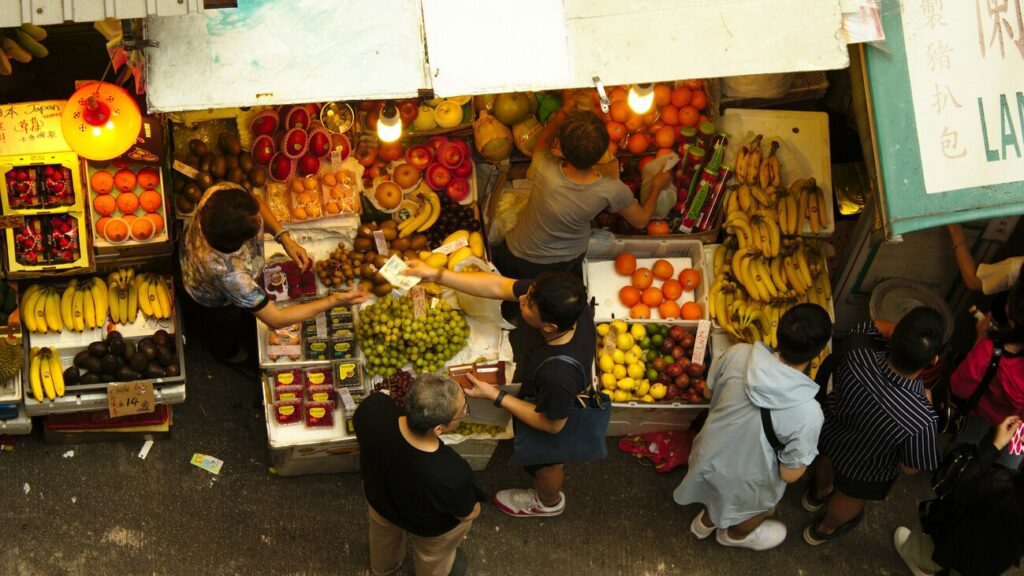 Community Markets Singapore : Shoppers exploring fresh produce at a local farmers’ market.Community Markets Singapore : Shoppers exploring fresh produce at a local farmers’ market.