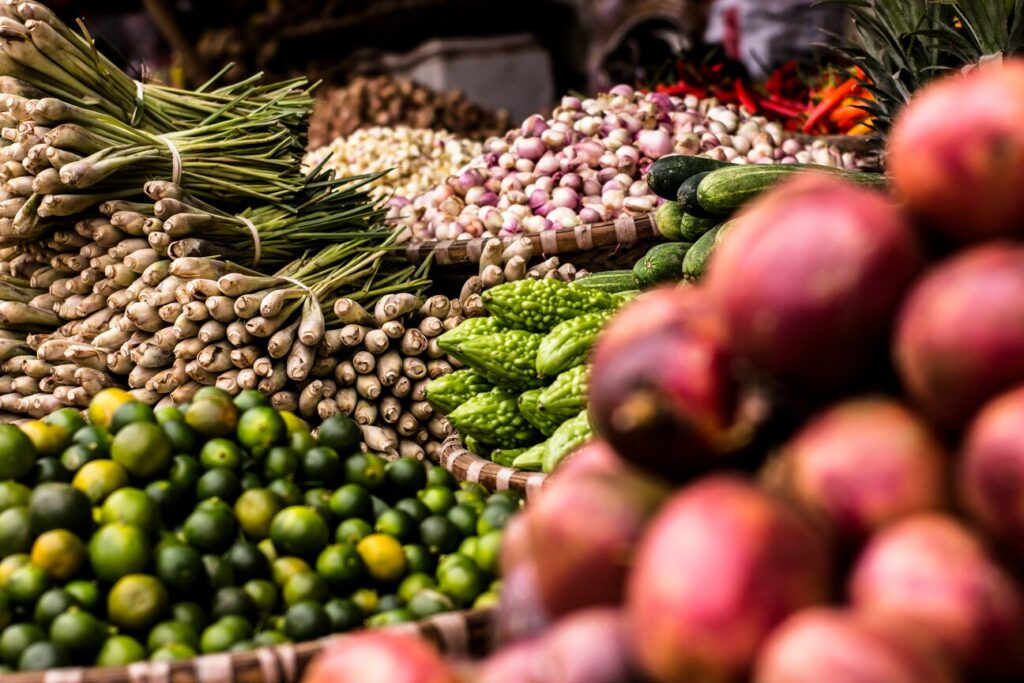 Community Markets Singapore : Vibrant market stalls offering seasonal fruits and vegetables in Singapore.