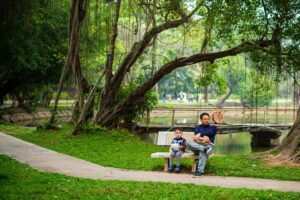 Best Park in SG: Parents and kids sitting together at scenic park trails.