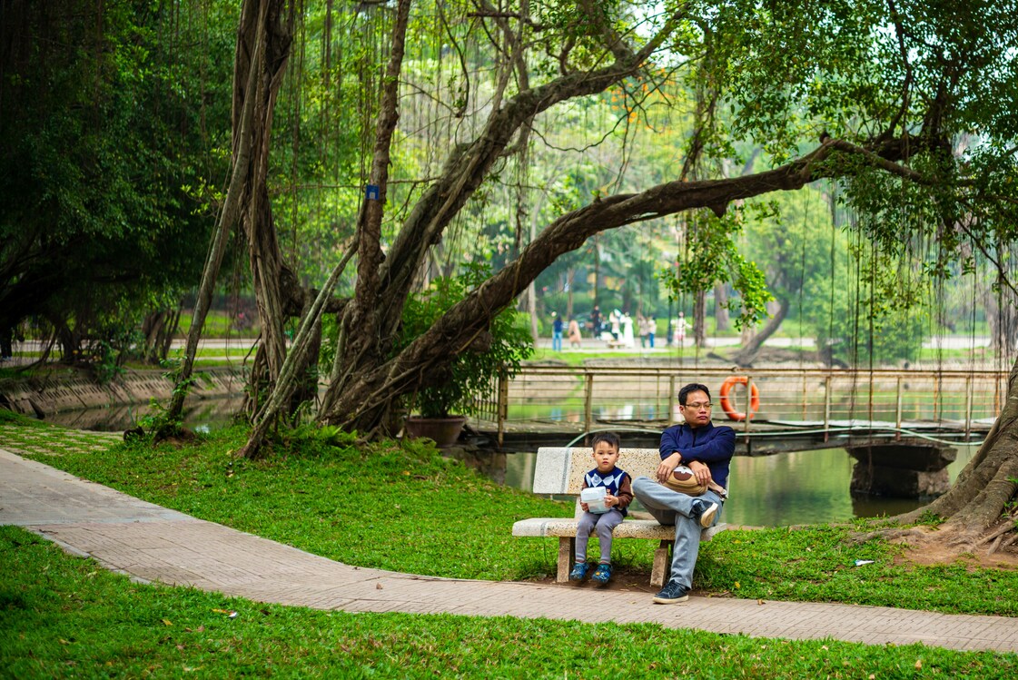 Best Park in SG: Parents and kids sitting together at scenic park trails.