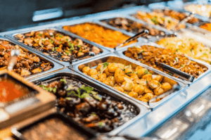 Buffet-style display of mouthwatering food at one of Singapore's iconic hawker centres, featuring stir fried char kway teow with flat rice noodles, chinese sausage, bean sprouts, and dark soy sauce, alongside hainanese chicken rice, nasi lemak with coconut milk, and other local dishes served by street food vendors. Captured at a bustling food centre like Maxwell Food Centre or Airport Road Food Centre, this vibrant scene showcases hawker stalls offering delicious noodles, rice, egg, shrimp, and sweet sauces—hallmarks of hawker culture in southeast Asia. A must visit spot for great food lovers exploring Singapore's hawker centers near the Singapore River, Chinatown, Lau Pa Sat, or the central business district. Perfect for a blog post or travel tips guide on hidden gems, satay street eats, roti prata, chilli crab, teh tarik, and other dishes found in open air food courts across the city and surrounding islands.
