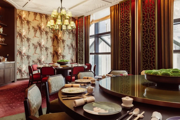 Eye‑level wide shot of an elegant private dining room with round tables, chandelier lighting, patterned wallpaper, and plush seating. Right: slightly elevated close‑up shot of a refined plated main course with sauce, vegetables, and garnish.