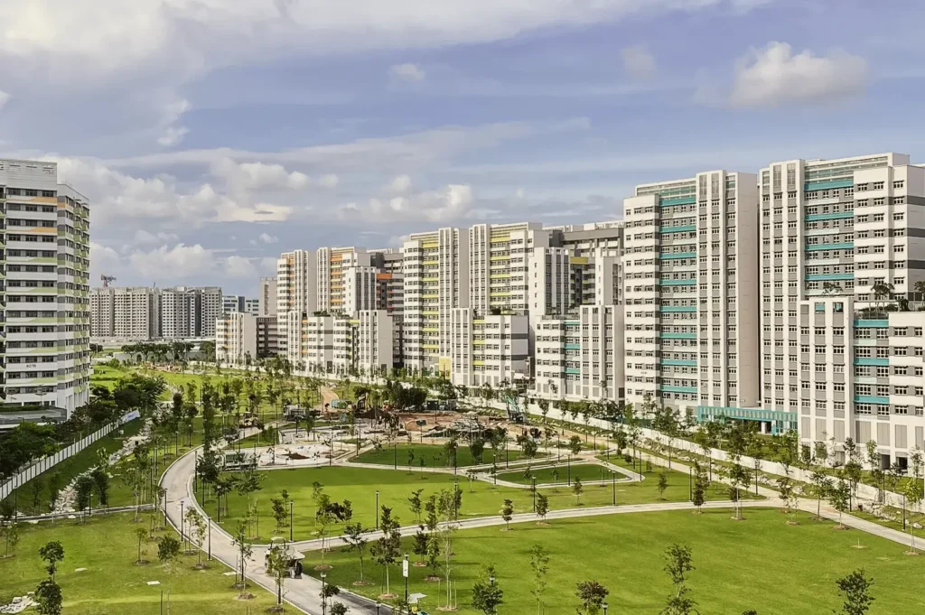 Residential district in Tampines, Singapore showing high‑rise HDB flats surrounding a landscaped park and green open spaces.