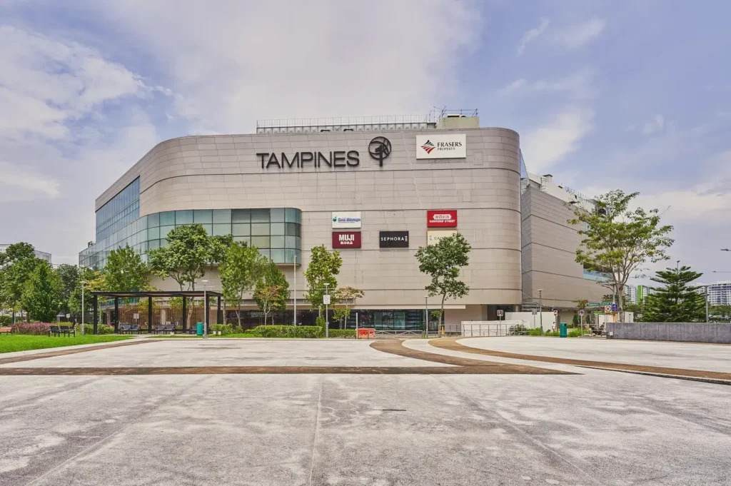 Tampines 1 Mall in Singapore featuring a contemporary shopping centre exterior with retail signage and open plaza space.