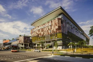 Our Tampines Hub in Singapore, a large integrated community and lifestyle complex with modern architecture along a major road junction.