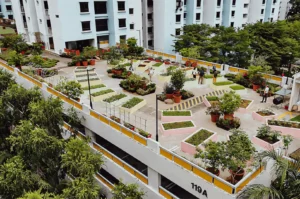 Community rooftop garden in Singapore featuring raised planting beds, potted greenery, and landscaped walkways within a residential housing complex.
