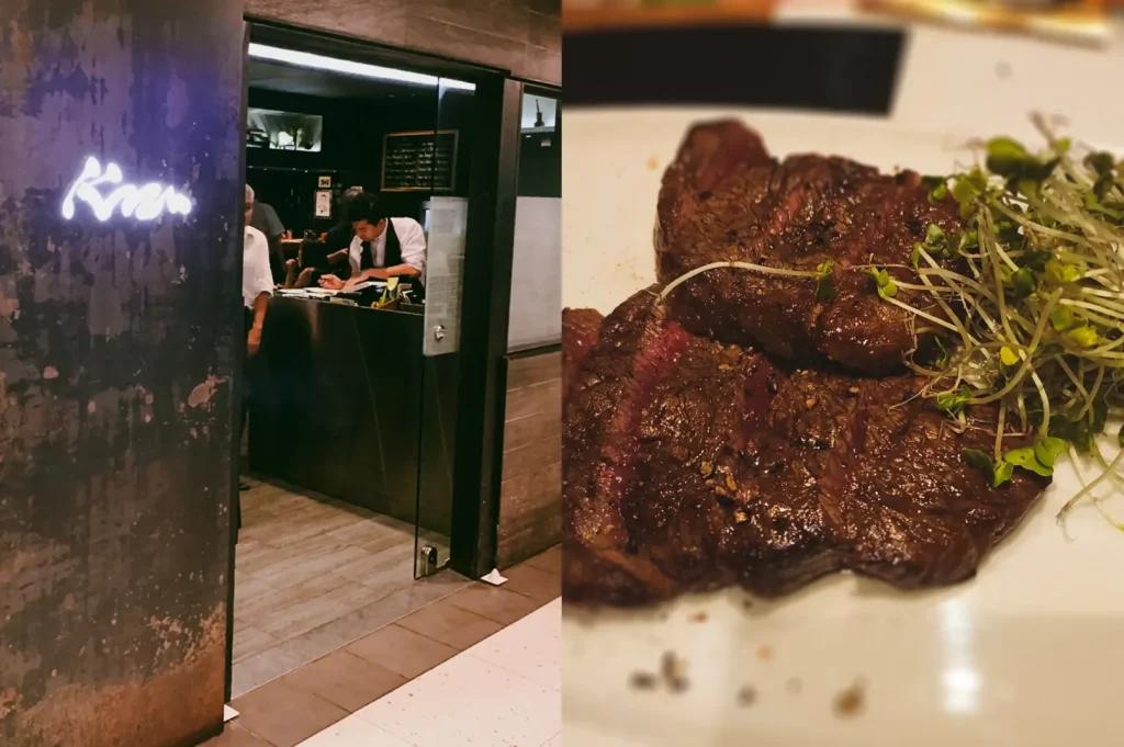 Left: Eye-level, three-quarter angle shot of a minimalist izakaya entrance with a partially open door revealing a counter seating area inside, a glowing Japanese-style logo on a dark textured wall, and staff working behind the counter under subdued, moody lighting. Right: Close-up, top-down shot of seared beef steak slices arranged on a white plate, showing a dark caramelized surface, coarse seasoning, and a small garnish of fresh green microgreens, softly lit to highlight the meat’s texture and juices.