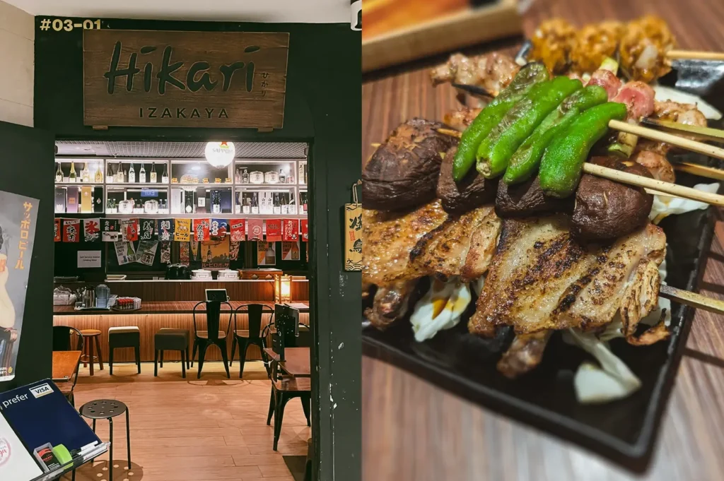 Left: Eye-level, wide-angle shot of the entrance to Izakaya Hikari at Fortune Centre, featuring a dark green doorway framing a warmly lit interior with wooden tables, bar seating, shelves of bottles, and hanging red-and-white Japanese banners beneath a wooden sign reading ‘Hikari Izakaya.’ Right: Close-up, three-quarter angle shot of assorted grilled izakaya skewers on a rectangular black plate, showing charred meat, mushrooms, and bright green shishito peppers with visible grill marks, set on a wooden tabletop under warm ambient lighting.