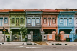 Wide-angle frontal view of colorful Peranakan shophouses along Koon Seng Road in Katong, featuring pastel facades, ornate tiles, and traditional terrace architecture in Singapore heritage district.