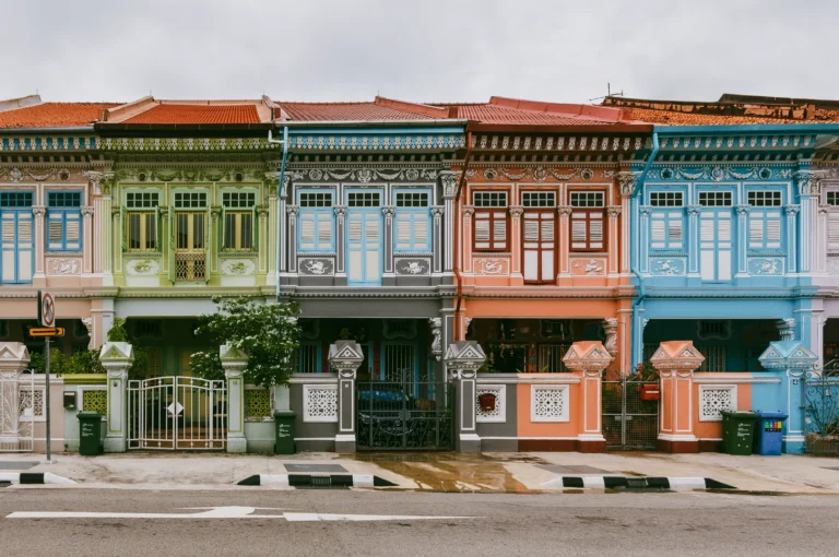 Wide-angle frontal view of colorful Peranakan shophouses along Koon Seng Road in Katong, featuring pastel facades, ornate tiles, and traditional terrace architecture in Singapore heritage district.