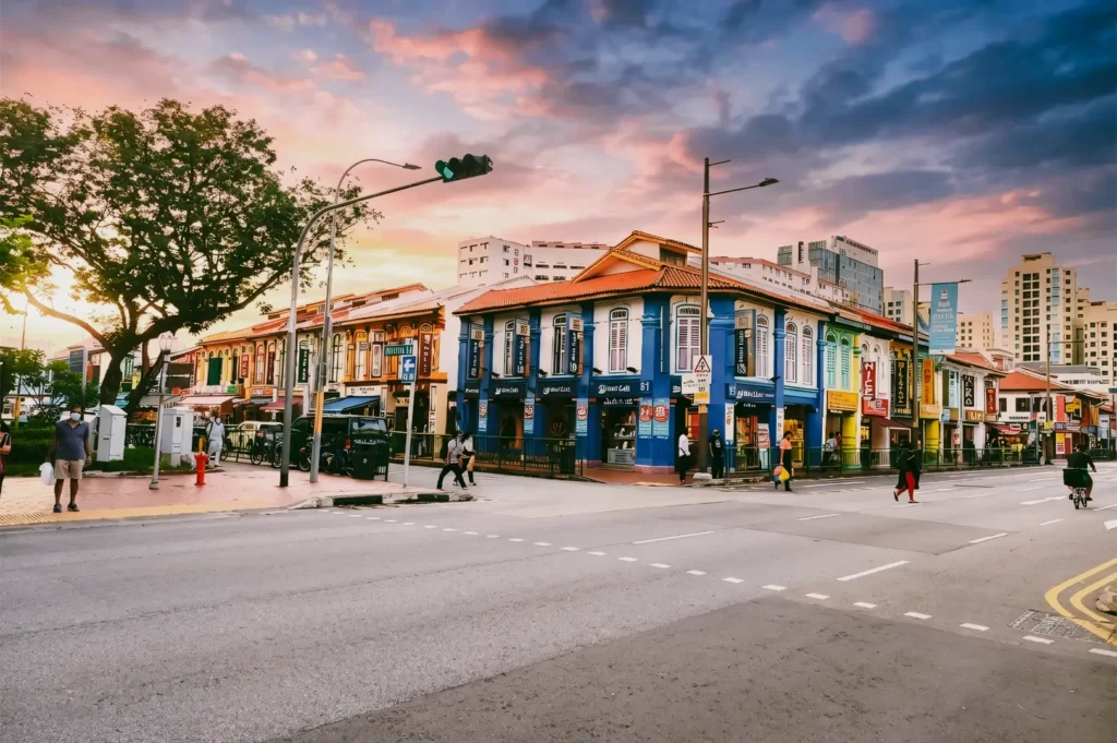 Little India Singapore street at sunrise with colorful shophouses and quiet roads near famous prata stalls, wide-angle street photography