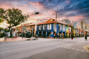 Little India Singapore street at sunrise with colorful shophouses and quiet roads near famous prata stalls, wide-angle street photography