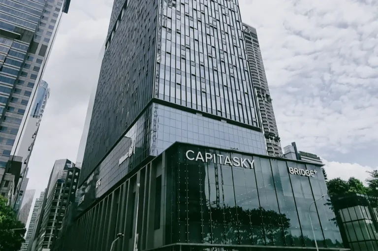 Low-angle view of CapitaSky at Tanjong Pagar, a modern glass skyscraper in Singapore’s CBD symbolizing the district’s role as a financial and business hub