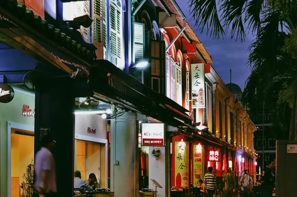 Evening street-level shot of illuminated shophouses and restaurants along Duxton Road in Tanjong Pagar, highlighting the district’s vibrant nightlife and dining scene