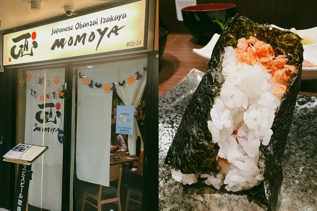 Left: Eye-level storefront view of ‘MOMOYA Japanese Obanzai Izakaya’ with illuminated signage, white curtain entrance, small menu stand, and festive garland decor in a compact indoor dining space; Right: Close-up three-quarter angle of a large onigiri rice ball wrapped in seaweed with visible salmon filling, placed on a textured plate with blurred bowls and tableware in the background.